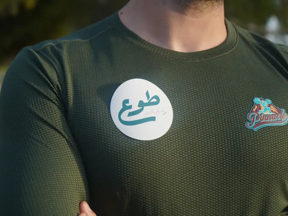 A founding volunteer wearing the Tawwa badge at Pinnacle Gym